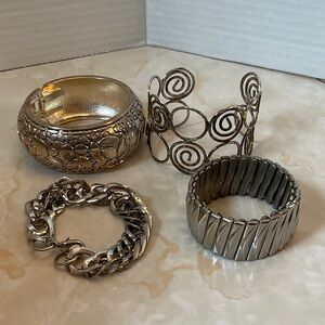 Set of Four Silver Tone bracelets Four different styles! See pics for details